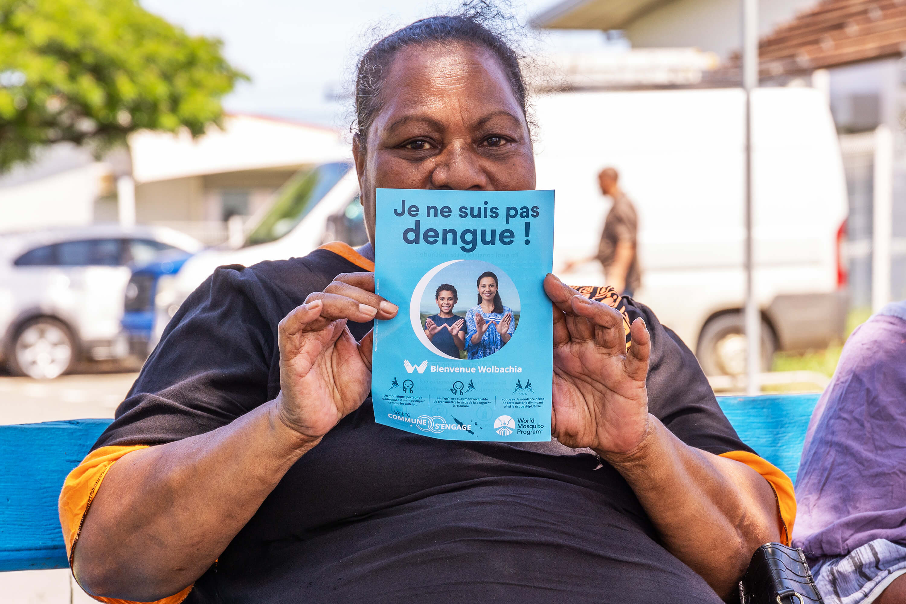 Woman holding Dengue factsheet